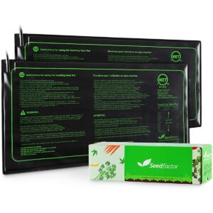 Three seedling heat mats with printed instructions visible on their surfaces, packaged in green and white cardboard boxes.